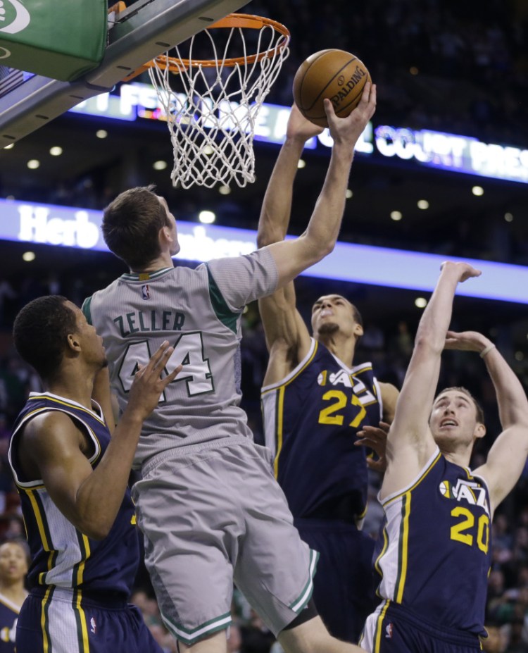 Celtics center Tyler Zeller goes up for the game-winning shot against Utah Jazz guard Rodney Hood (5), center Rudy Gobert (27) and forward Gordon Hayward (20) at the final buzzer of Wednesday night’s game in Boston. The Celtics won, 85-84.