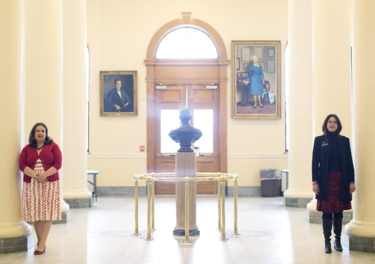 State Reps. Diane Russell, D-Portland, left, and Deborah Sanderson, R-Chelsea, take opposite sides in the State House Hall of Flags in Augusta. There aren’t many public policy issues the two agree on, but expanding access to medical marijuana is one of them.