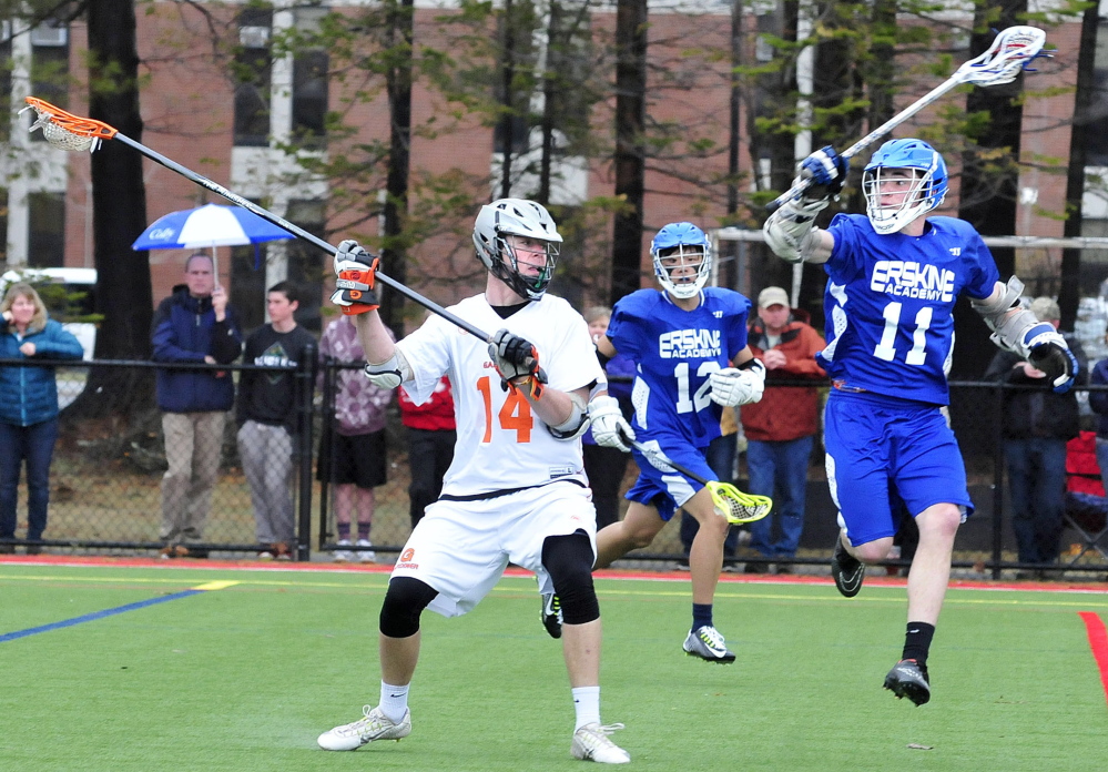 Gardiner’s Jake Truman prepares to score as Erskine’s Duan Pengyn, center, and Josh Reed cover during a game Tuesday in Waterville. The Tigers beat the Eagles 25-2.