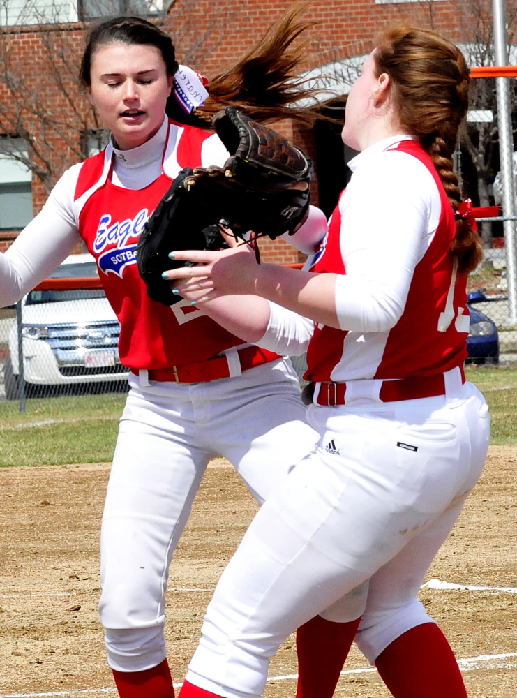 Messalonskee players Kirsten Pelletier, left, and Hannah Duperry both try to catch a pop-up in the infield for an out during a game against Skowhegan on Wednesday.