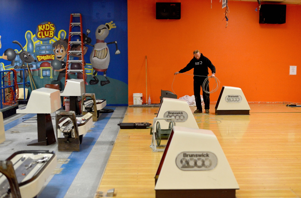 Galen Gould, maintenance and technical manager at SpareTime Recreation on West River Road in Waterville, breaks down the bowling machines on Tuesday. The bowling alley has been sold and is being converted to a church.