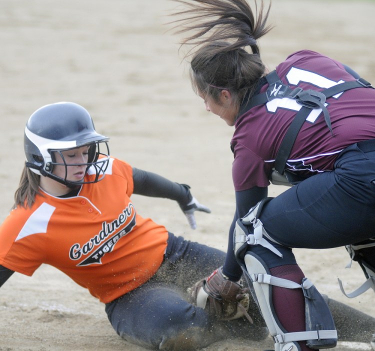 Staff photo by Andy Molloy 
 Gardiner Area High School's Bri Brochu gets tagged at home by Nokomis catcher Mikayla Charters during a Kennebec Valley Athletic Conference Class B game Wednesday.