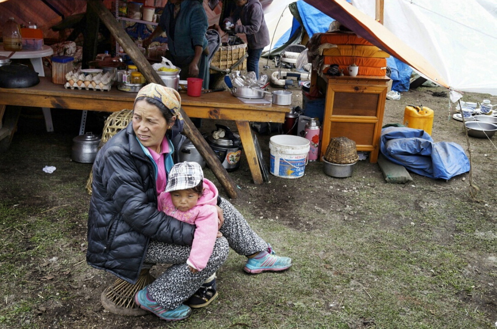 A woman holds her child Wednesday outside a tent made from a tarp in the village of Thame, Nepal. The remote village was destroyed by the April 25 earthquake, leaving residents to fend for themselves.
Photo by Doug Bruns