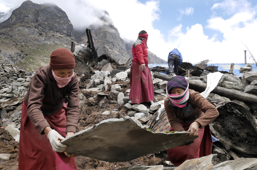 Nuns from a monastery in the decimated village of Thame assist in the recovery effort Wednesday. “Life in these villages is hard, harsh and often deadly,” said Portland’s Doug Bruns.