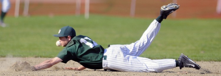 Winthrop High School’s Cabot Lancaster dives over second base to try and grab the ball during a Mountain Valley Conference game Monday in Farmingdale.