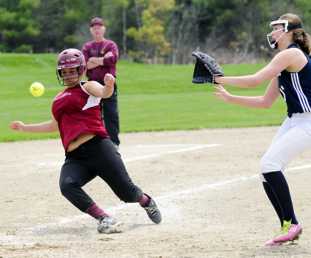 Richmond’s Kelsie Obi, left, slides towards home, as Greenville pitcher Lily Pelleter covers the plate, to score from third on a wild pitch during a game on at the Burney-Gardner Community Memorial Athletic Complex in Richmond.