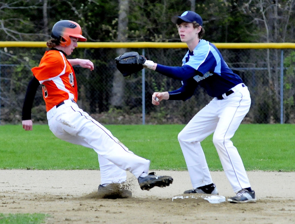 Winslow’s Ben Smith makes it back to second base as Oceanside’s Jimmy Strong waits for the throw Monday in Winslow. Oceanside won 7-1.