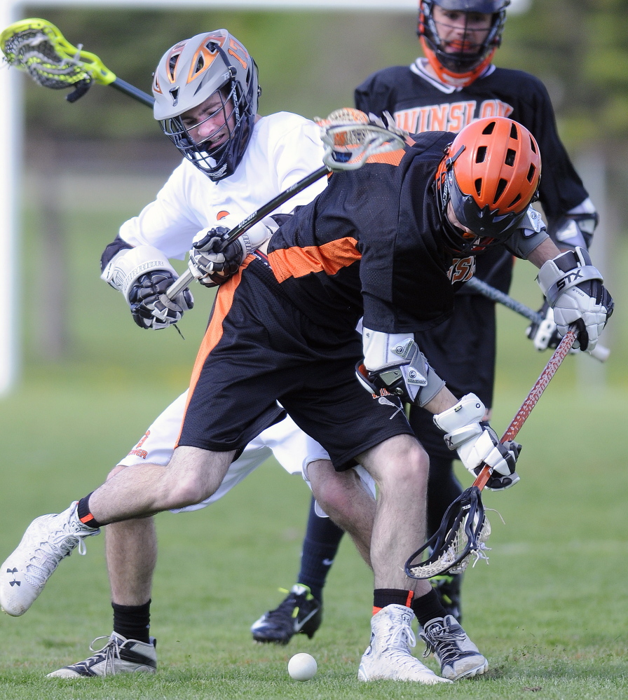 Gardiner Area High School’s Cam Bell, left, collides with Winslow High School’s Jacob Houghton during a lacrosse game Wednesday in Gardiner.