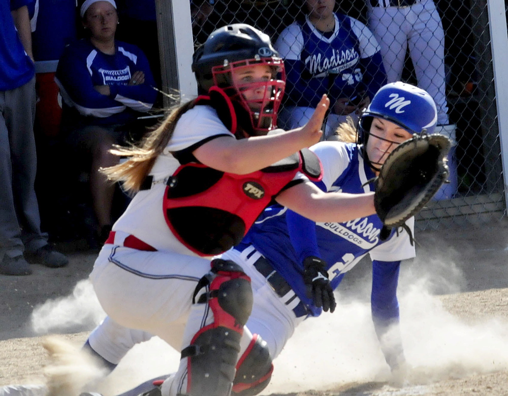 Madison’s Kayla Bess beats the throw to home as Hall-Dale’s Emma Begin, left, covers during a game in Madison on Thursday. Madison won 9-5.