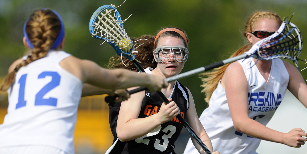 Gardiner Area High School’s Evelyn Hinkley, center, maneuvers past Erskine’s Madison Michaud, left, and Kaitlyn Darveau during an Eastern B game Tuesday.