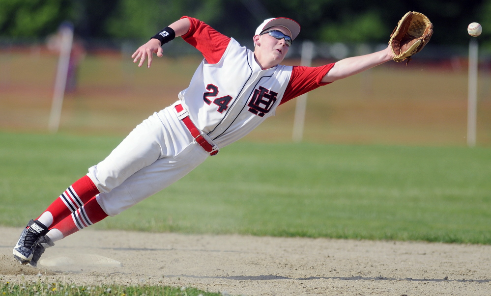 Hall-Dale High School’s Josh Cowing dives for a throw to second base during a game against Oak Hill High School on Tuesday in Farmingdale.