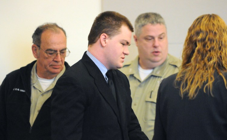 Kyle Dube is escorted into the courtroom at the Penobscot Judicial Center before his sentencing on Friday. Dube, who used a phony Facebook profile to lure 15-year old Nichole Cable to her death, was sentenced to 60 years in prison.