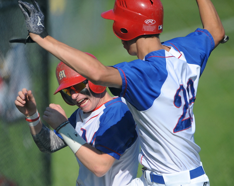 Staff photo by Michael G. Seamans 
 Messalonskee teammates Trevor Gettig, left, and Nick Mayo celebrate after the Eagles scored the first run of an Eastern A quarterfinal game Thursday in Oakland.