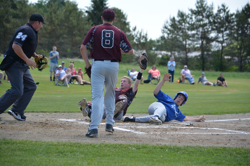 Richmond catcher Brendan Emmons holds onto the ball after a collision at the plate with Valley baserunner Collin Miller in the top of the first inning in a Western D semifinal Saturday in Richmond. Center fielder Tyler Soucy threw Miller out on a bang-bang play. The out proved big as Richmond held on for a 4-3 victory.