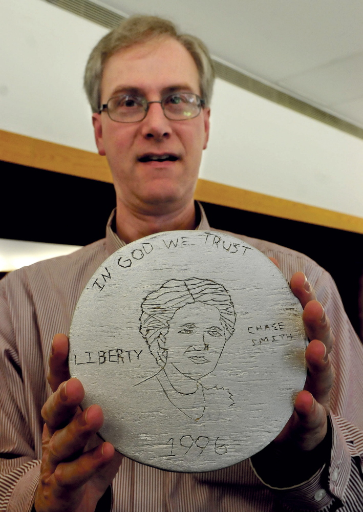 David Richards, director of the Margaret Chase Smith Library in Skowhegan, holds a coin with the likeness of Smith created by Benton Elementary school student Tia Nichols in 1996. Richards and others are hoping the late senator from Maine is considered to be on the $10 bill.