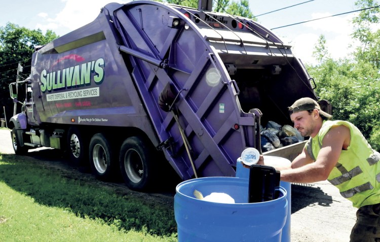 Jerry Allen, an employee of Sullivan’s Waste, empties recyclables into a company truck recently. The Thorndike company has the contract to pick up Waterville’s residential recycling the first and third weeks of the month. Mayor Nick Isgro and city councilors were surprised that the city administration announced that no arrangements were to be made to pick up recyclables on “odd” weeks in months with five weeks.