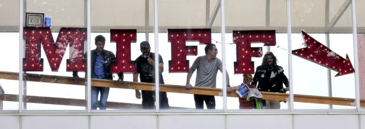 People look out over Castonquay Square from the Maine International Film Festival-decorated crosswalk beside the Waterville Opera House, where student films and videos were shown on Saturday.