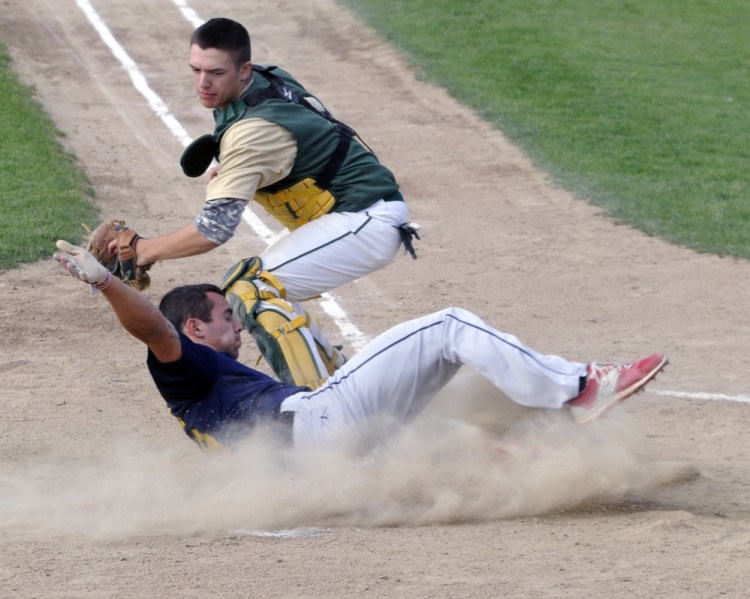 Augusta baserunner Tayler Carrier slides safely home to score the second of two runs on a hit by teammate Taylor Lockhart during a Zone 2 American Legion playoff game Thursday at McGuire Field in Augusta. The throw to Bessey catcher Matt Smith wasn’t in time to get him out.