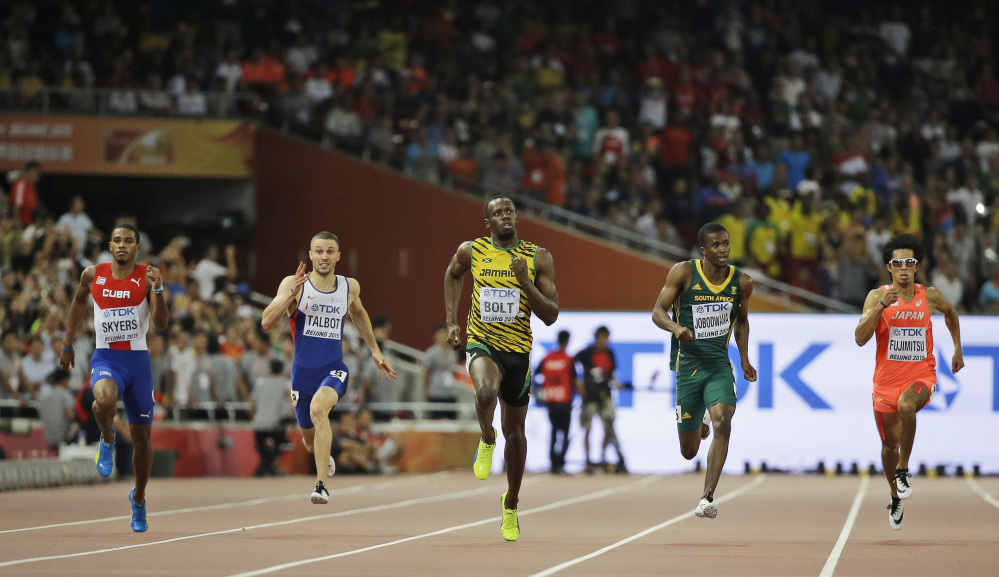 Usain Bolt, middle, competes in a men’s 200m semifinal at the World Athletics Championships at the Bird’s Nest stadium in Beijing on Wednesday.