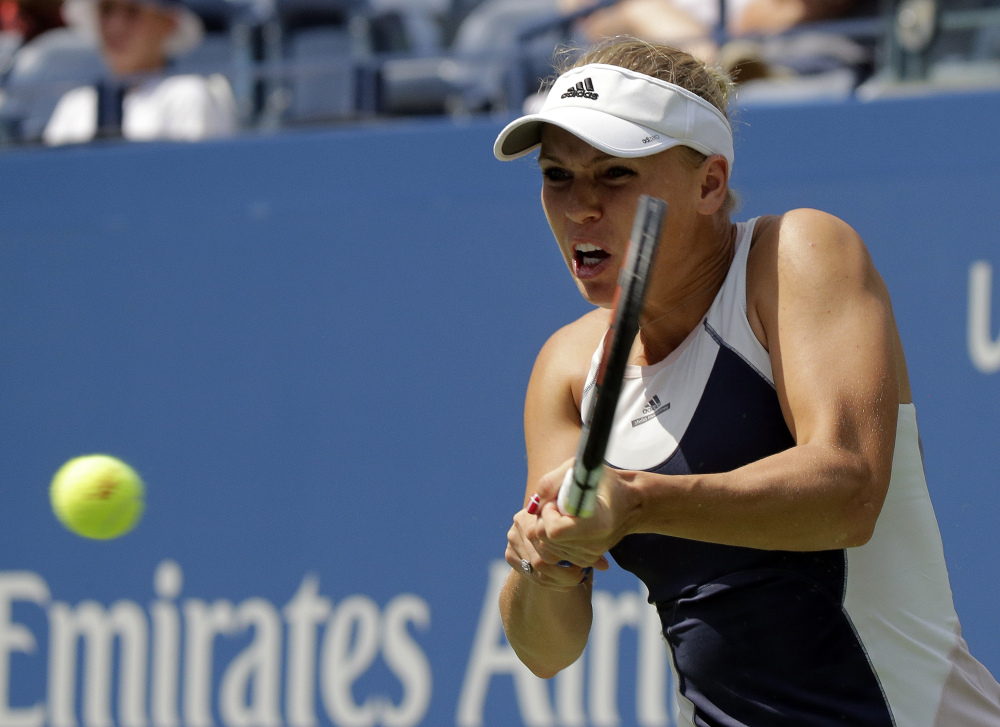 Caroline Wozniacki returns a shot to Jamie Loeb during the first round of the U.S. Open on Tuesday in New York.