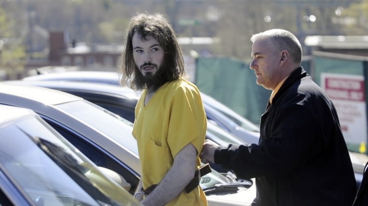 Leroy H. Smith III speaks to reporters as he is led to a car in this May 2014 file photo following his initial appearance in Kennebec County Superior Court.