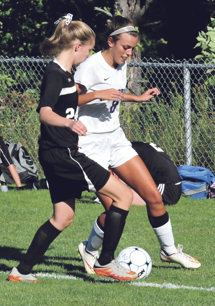 Maranacook’s Grace Despres, left, and Waterville’s Jordan Jabar compete for possession during a Class B game Tuesday at Webber Field in Waterville.