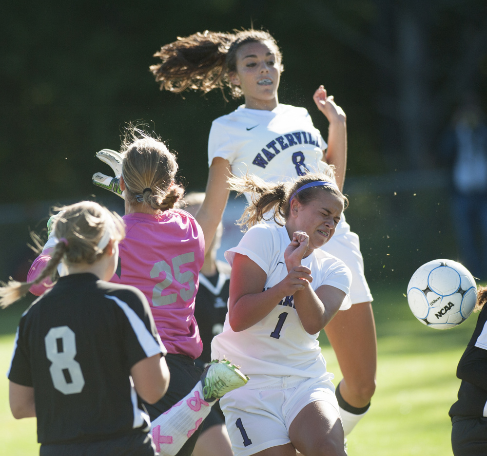 Kevin Bennett photo 
 Waterville's Mackenzie St. Pierre and Winslow keeper Hillary Libby seek control of the ball in front of the Winslow net Saturday at Waterville.