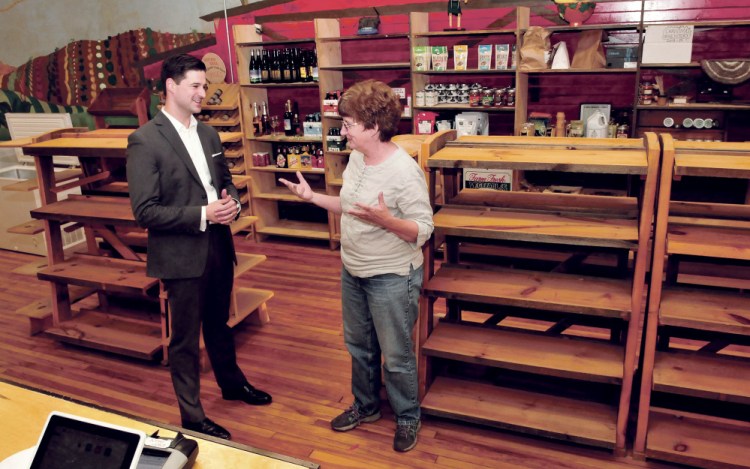 Waterville Mayor Nick Isgro and Holy Cannoli owner Candace Savinelli converse on Monday in the former Barrels Community Market store in Waterville. The two plan to open an Italian market in the closed store.