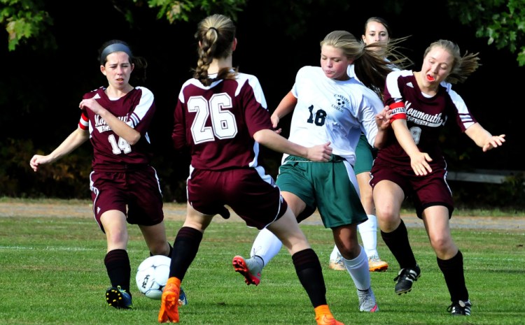 Staff photo by David Leaming 
 Carrabec's Makayla Vicneire is sandwiched between Monmouth players, from left, Taylor Spadafora, Emily Grandahl and Maddie Bumann, during a Mountain Valley Conference game Monday afternoon in North Anson.