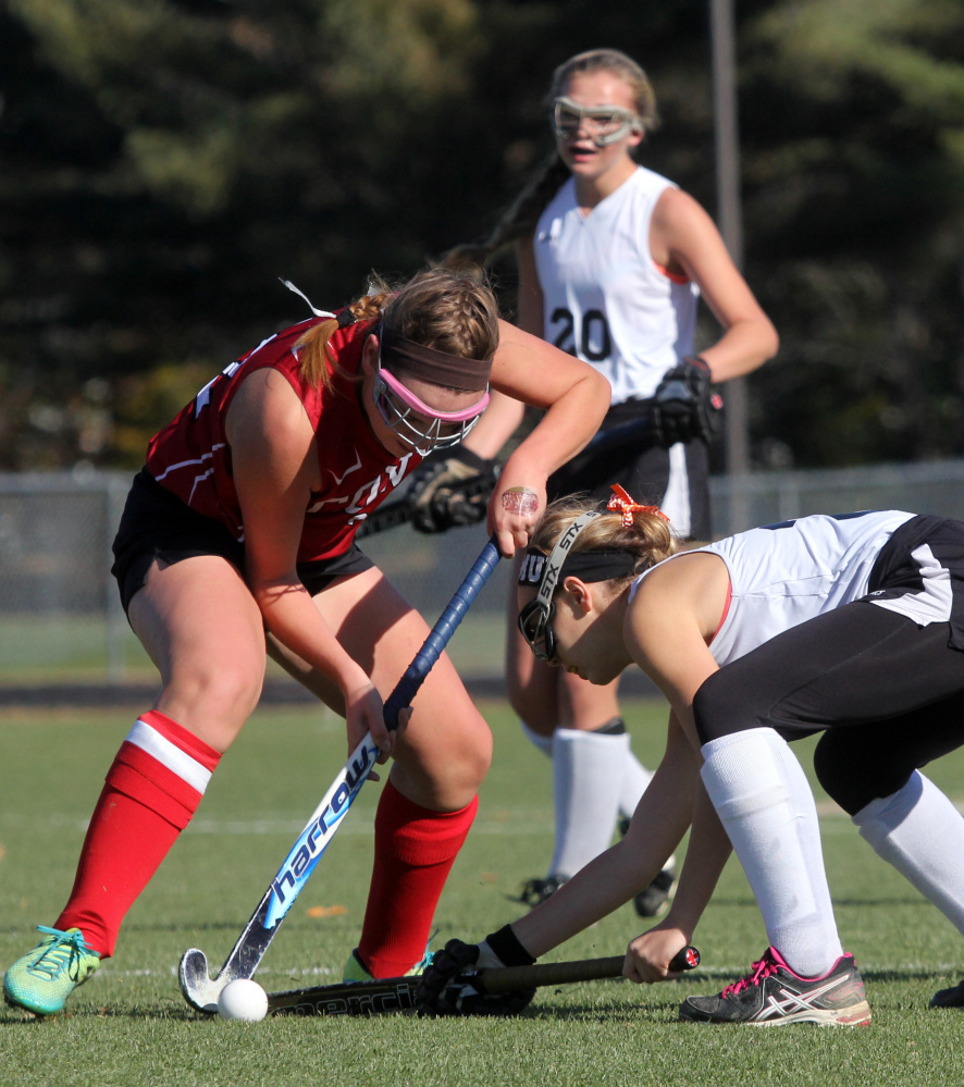 Photo by Jeff Pouland 
 Cony High School's Abigail Silsby tries to move the ball around Skowhegan's Rylie Mullen during the first half of a Class A North seminfinal game Saturday in Skowhegan.