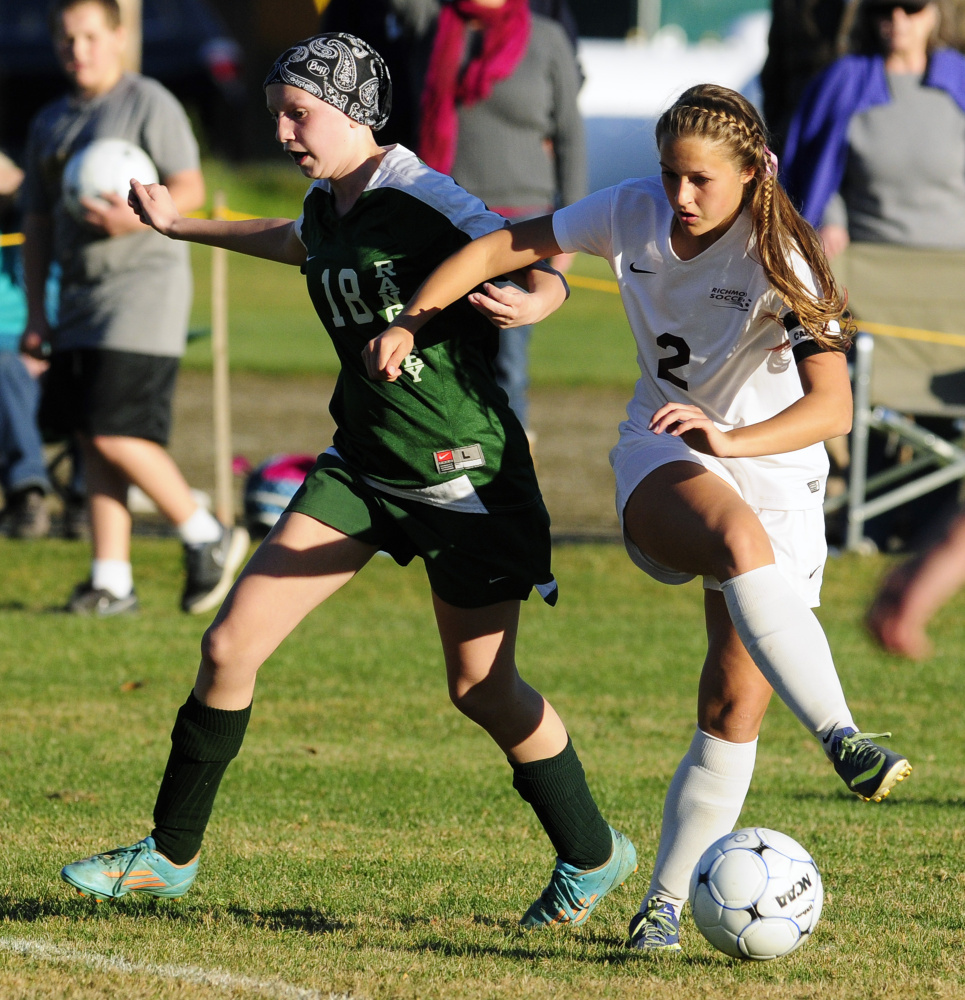 Rangeley’s Brooke Egan, left, and Richmond’s Autumn Acord battle for possession during the Class D South final Wednesday in Richmond.