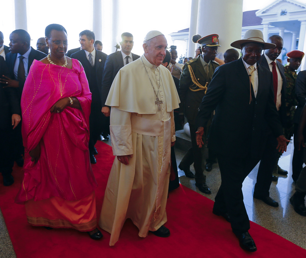 Pope Francis meets with Uganda’s President Yoweri Kaguta Museveni, right, and his wife, Janet, in Entebbe, Uganda, on Friday. 