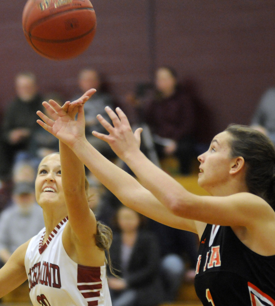 Richmond High School’s Autumn Acord tips the ball away from North Yarmouth Academy’s Corinne Poitras on Wednesday in Richmond.