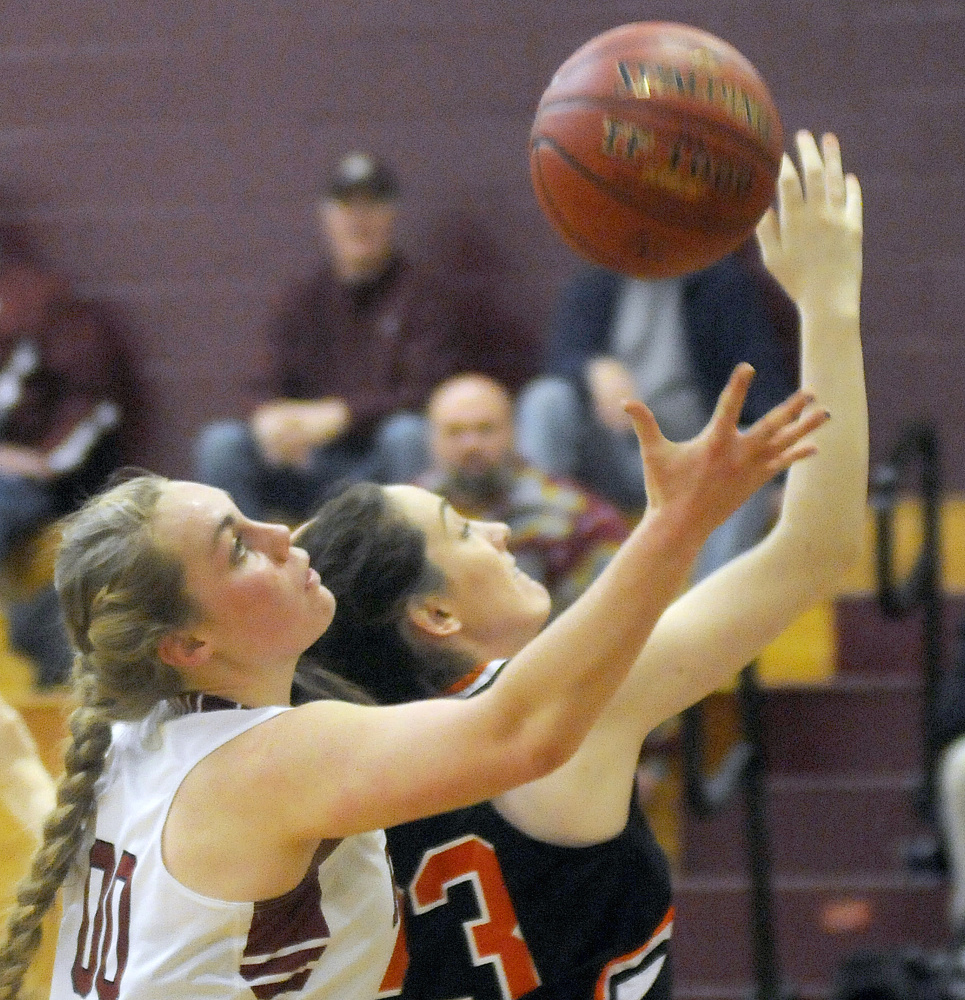 Richmond High School’s Sydney Tilton goes after a rebound with North Yarmouth Academy’s Cameron Woods on Wednesday in Richmond.