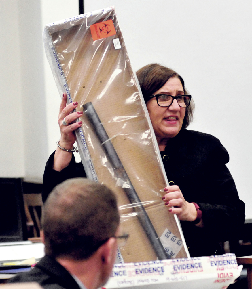 Assistant Attorney General Leanne Zainea holds a pipe as evidence that will be used in the murder trial of defendant Jason Cote accused of killing Ricky Cole during the first day of Cote’s trial in Somerset County Superior Court in Skowhegan on Dec. 10.