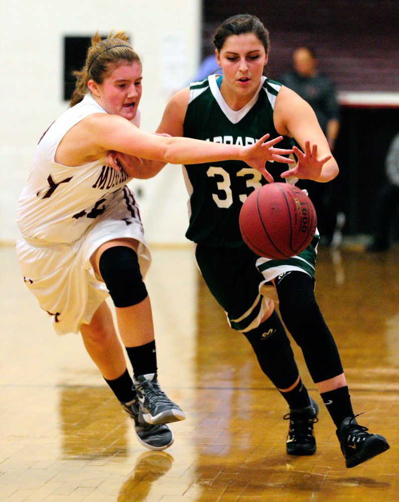 Monmouth’s Abbey Allen, left, tries to steal ball from Carrabec’s Mickayla Willette on Thursday in Foster Gym at Monmouth Academy.