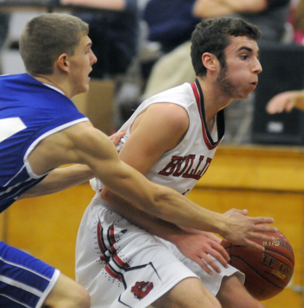 Hall-Dale High School's Tyler Nadeau, right, evades Madison Area Memorial High School's Chris Beaman on Monday in Farmingdale.