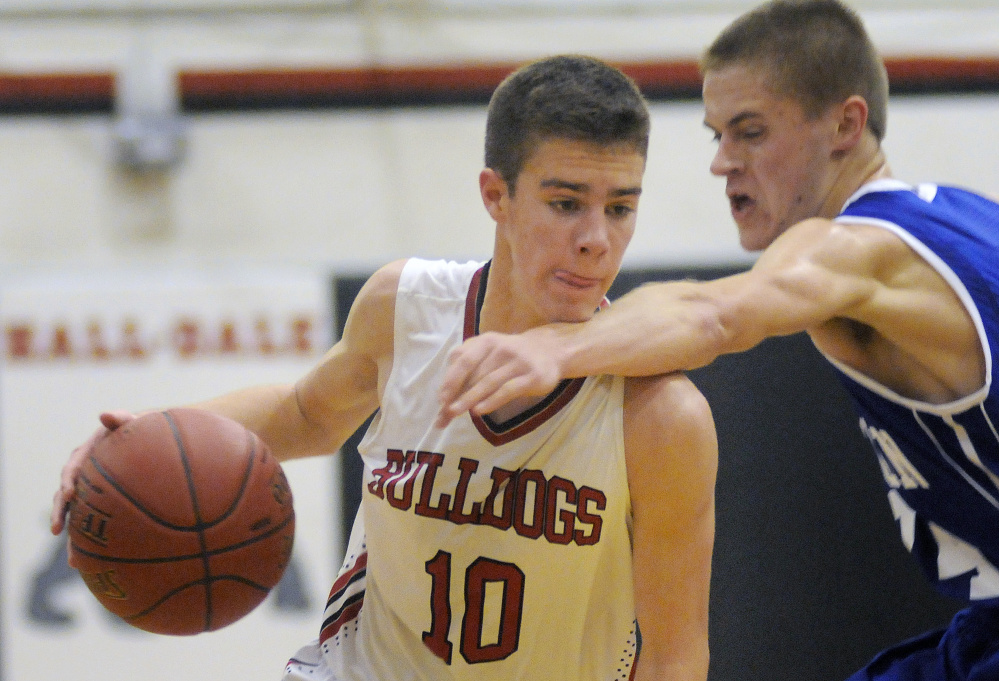 Hall-Dale High School's Alec Byron runs through the arms of Madison Area Memorial High School's Ty Greene on Monday in Farmingdale.