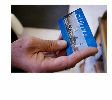 Staff Photo by Shawn Patrick Ouellette:  Keven Gillette of Portland uses a magnetic food stamp card to buy his groceries Monday, August 11, 2008.