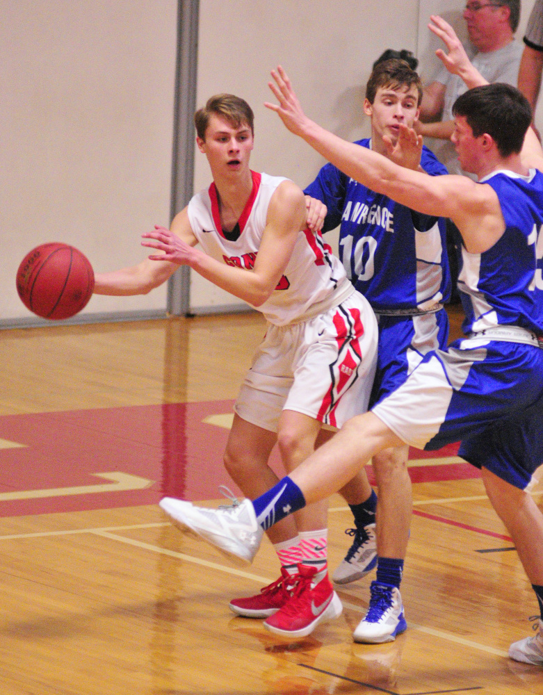 Cony’s Carter Cleaves, left, looks for a teammate to pass to while Lawrence’s Mason Cooper and Seth Powers defend him during a game Saturday at Cony High in Augusta.