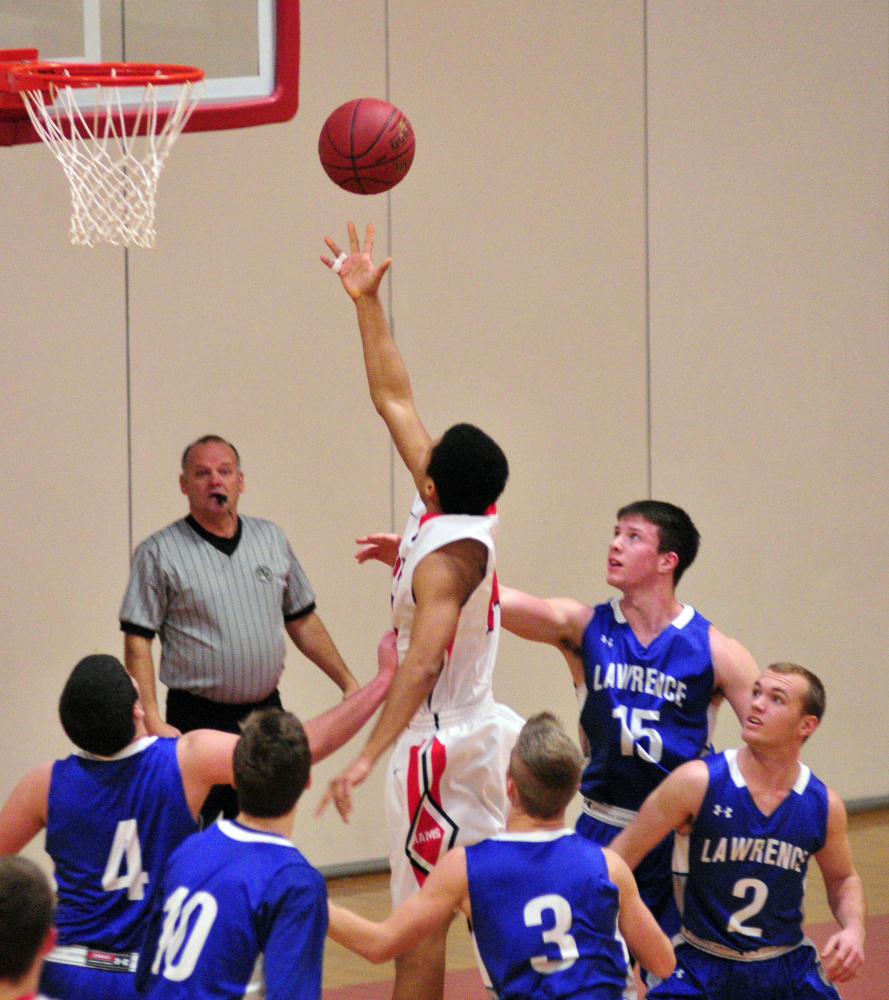 Cony’s Jordan Roddy is surrounded by the entire Lawrence defense as he shoots during a game Saturdayat Cony High in Augusta.