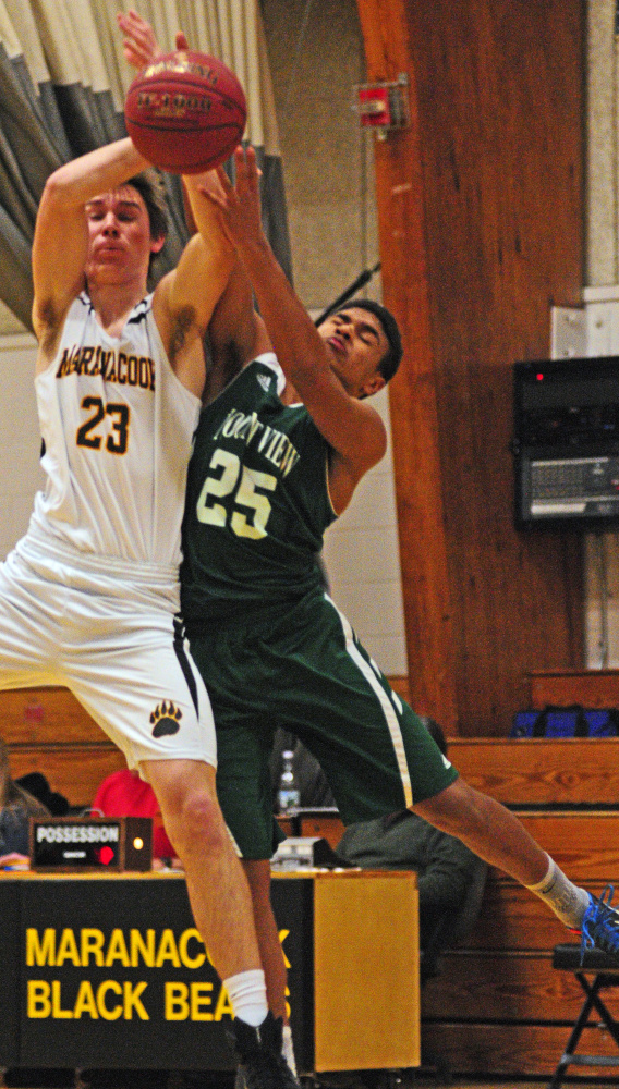 Maranacook’s Levi Emery (23) and Mount View’s Devon Davis go for rebound during a game Tuesday in the Mr. Burbank Memorial Gym in Readfield.