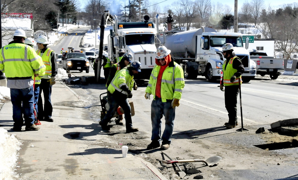 Employees of Summit Natural Gas of Maine and subcontractors work on the gas pipeline in the center of Norridgewock in 2014. The company announced Friday that 21 workers — 13 positions in its Augusta office and eight from its conversion affiliate -- will be losing their jobs.