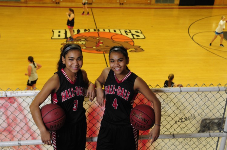 Thea Sweet, left, and sister Dani Sweet pose during practice Tuesday at Penny Memorial Gym in Farmingdale.