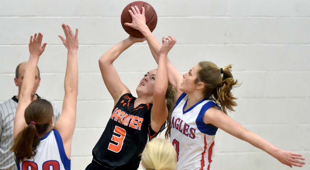 Messalonskee’s Sophie Holmes, right, blocks a shot by Gardner’s Mikayla Bourassa during a Kennebec Valley Athletic Conference Class A game last month in Oakland. The Eagles and Tigers open Class A North quarterfinal round play Friday at the Augusta Civic Center.