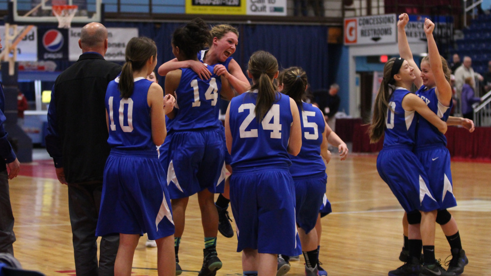 Members of the seventh-seeded Valley girls basketball team celebrate after they upset No. 2 Forest Hills 31-22 in a D South quarterfinal Saturday afternoon at the Augusta Civic Center.