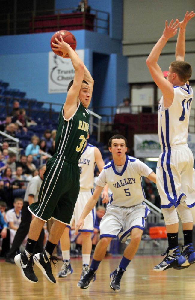 Rangeley’s Kyle LaRochelle tries to pass the ball as Valley’s Luke Malloy, left, applies some pressure during the first half of a Class D South quarterfinal at the Augusta Civic Center on Saturday.