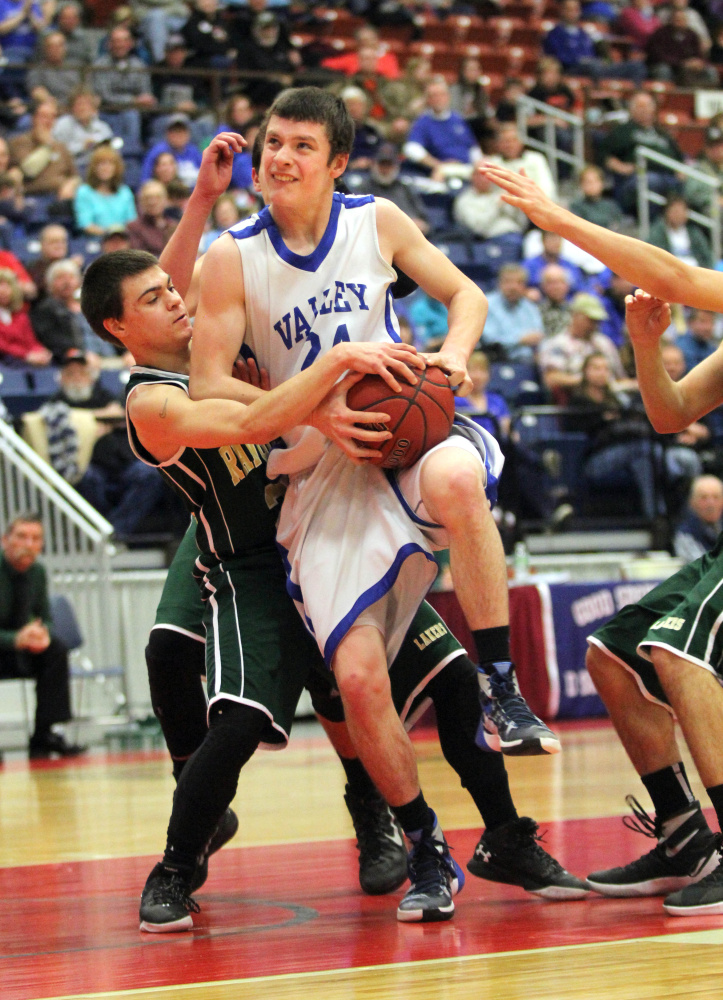 Valley’s Austin Cates gets fouled by Rangeley’s Carl Trafton on a drive to the basket during the first half of a Class D South quarterfinal Saturday at the Augusta Civic Center. Valley won 62-33.