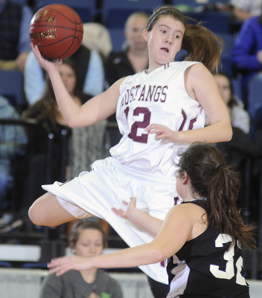 Monmouth’s Abbey Allen keeps the ball in play as St. Domini’s Allie Veinote defends during a Class C South quarterfinal Monday at the Augusta Civic Center.