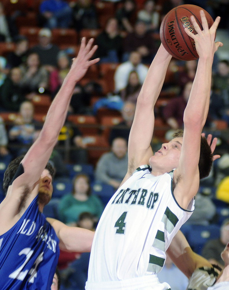 Winthrop High School’s Spencer Steele (4) grabs the ball over Old Orchard Beach High School’s Evan Christensen on Monday in Augusta.